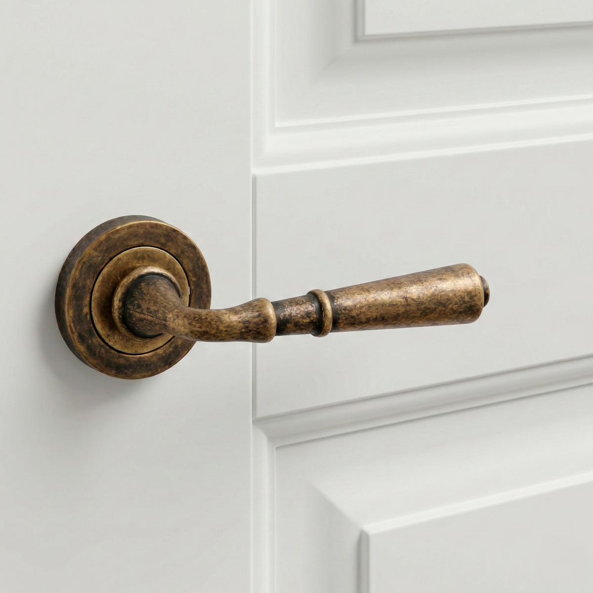 '507' model door handle with round rose in aged leather finish