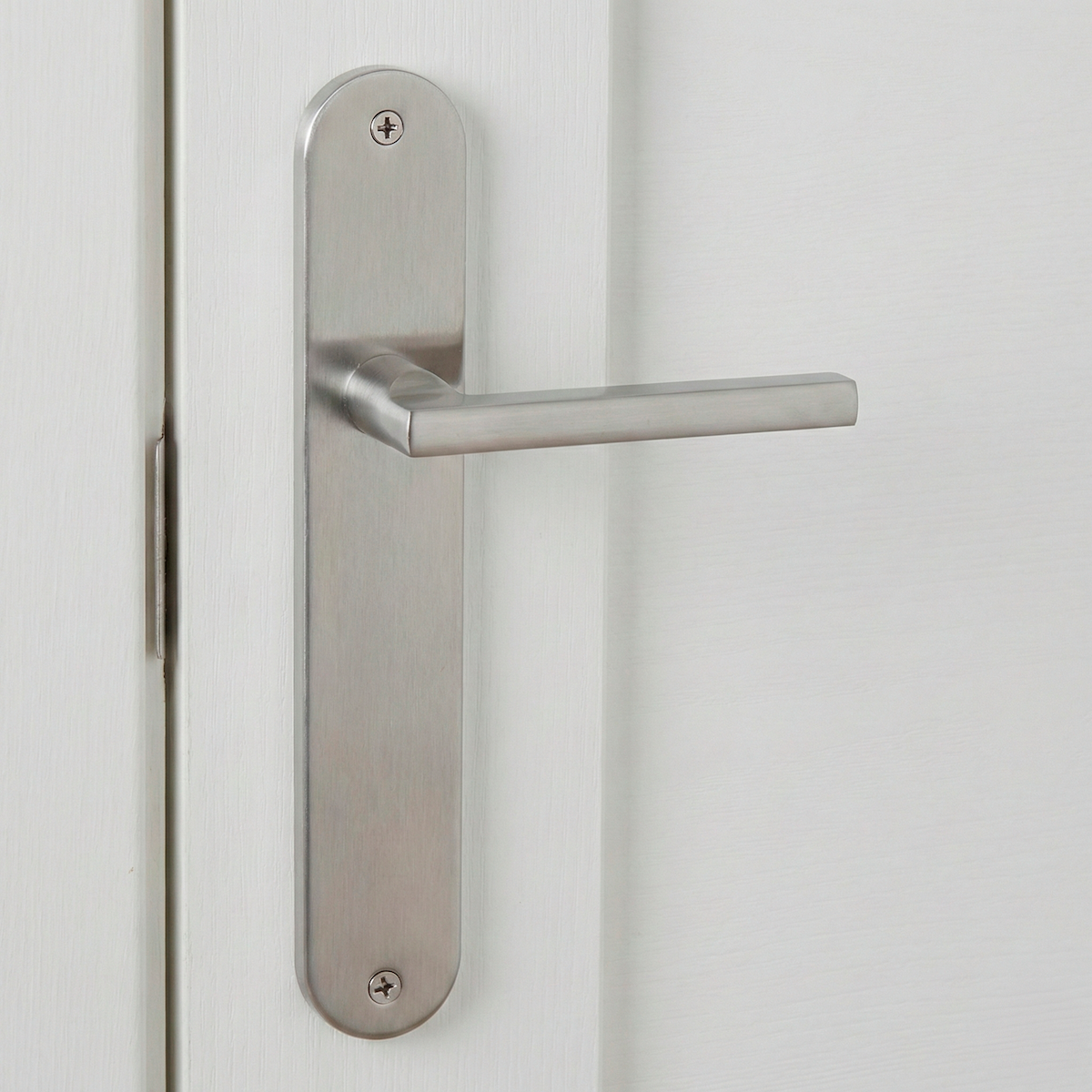 Clásica manilla modelo '530' de aluminio con placa oval en acabado níquel satinado para puertas