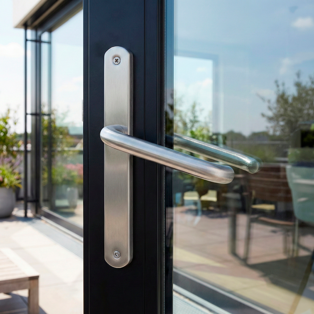 '603' model stainless steel lever handle with narrow backplate for exterior doors